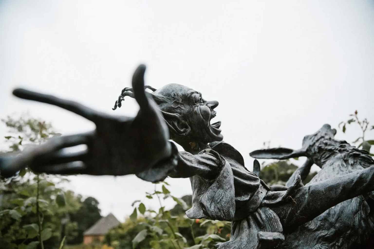 Close-up of a whimsical garden sculpture with an outstretched hand at Comlongon Castle, Scotland